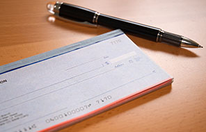 pen laying beside a checkbook