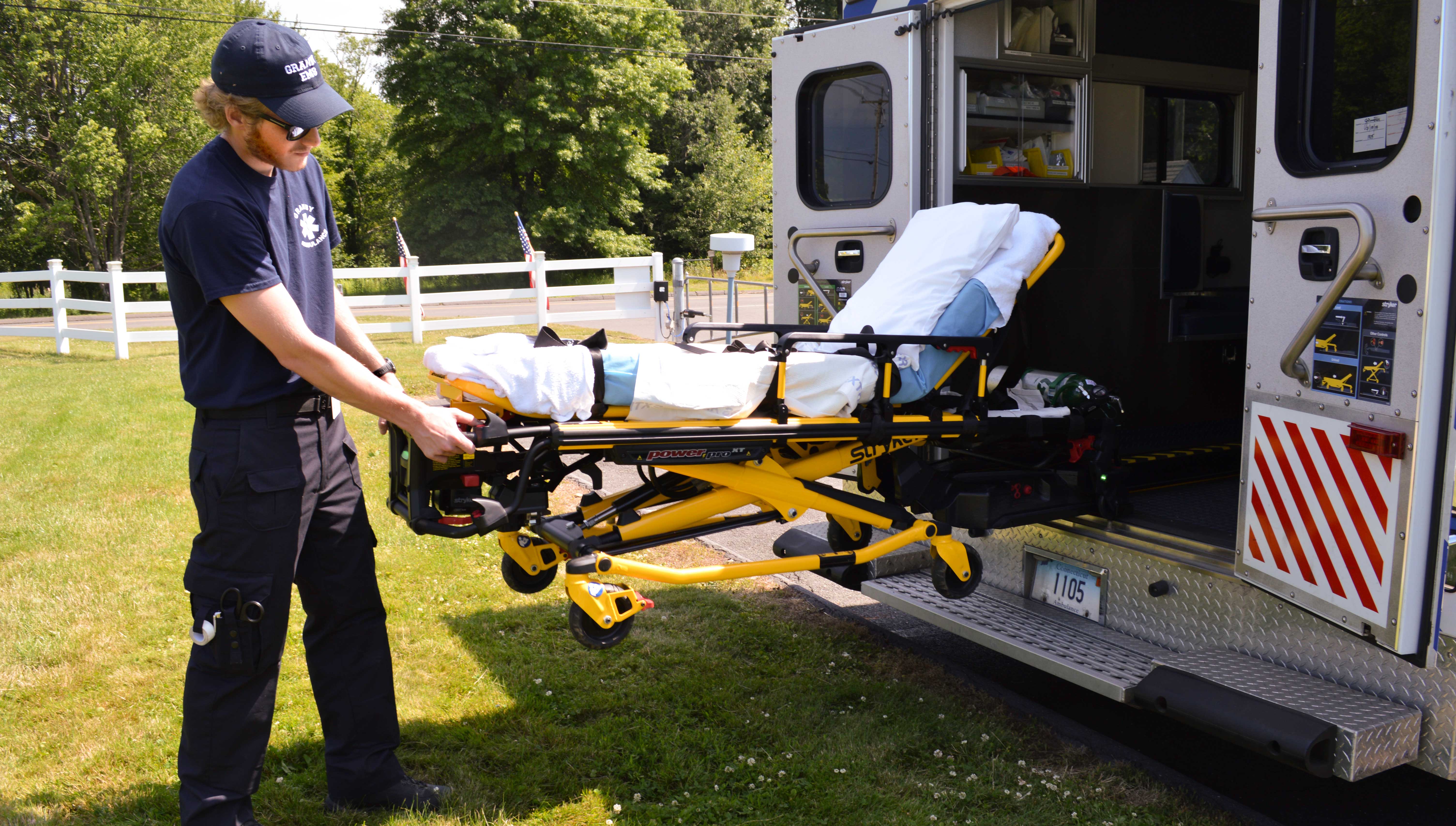 volunteer-emt Granby Ambulance Association EMT operates the power assisted stretcher.